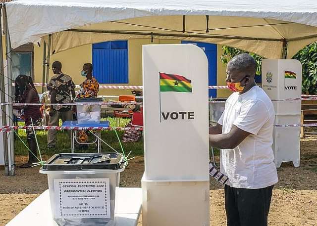 Polling station sign and voters queue in Akwatia for by-election Polling station sign and voters queue in Akwatia for by-election